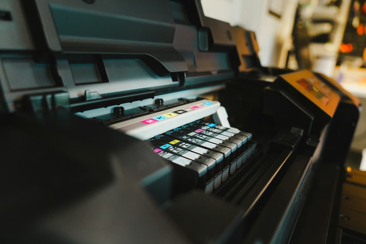 Colour ink cartridges in an open printer.